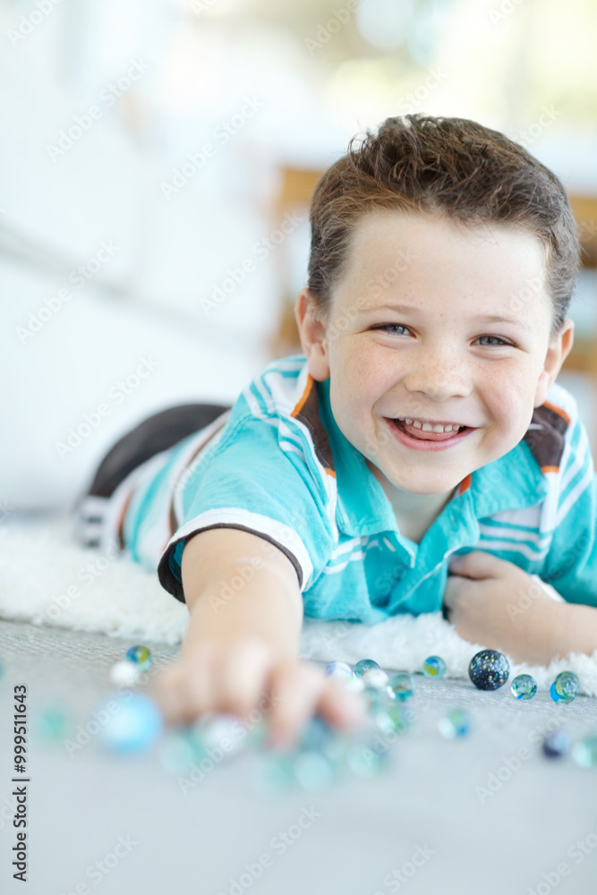 Smile, portrait and child play with marbles on floor for funny game, relax or laugh in home. Face, happy boy and cute kid with glass balls or toys on carpet for creative collection or excited in USA Smile, portrait and child play with marbles on floor for funny game, relax or laugh in home. Face, happy boy and cute kid with glass balls or toys on carpet for creative collection or excited in USA