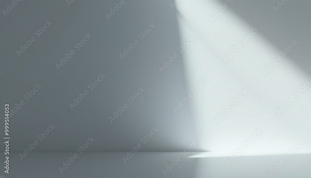 Minimalist grey studio background with a beam of light.
