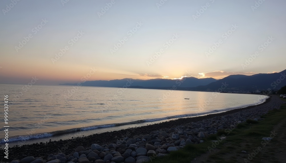 Sunset over tranquil waters with rocky shore Sunset over tranquil waters with rocky shore
