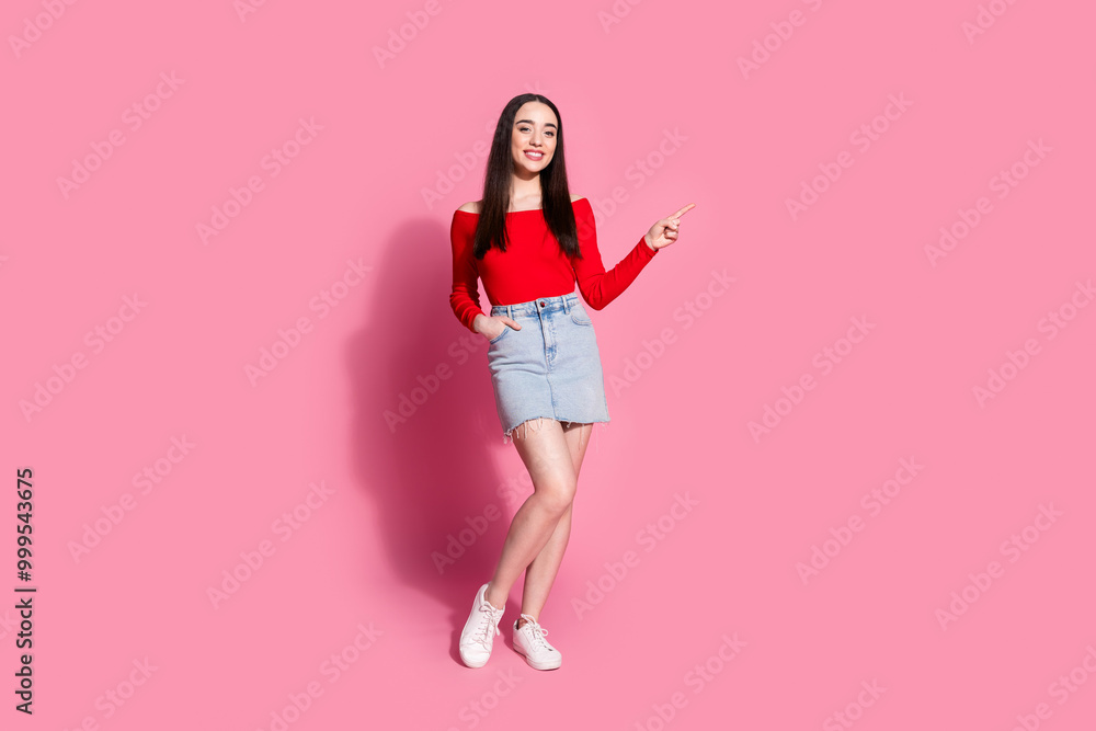 Full size photo of gorgeous young woman direct finger empty space isolated on pink color background Full size photo of gorgeous young woman direct finger empty space isolated on pink color background