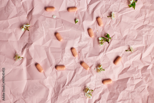 Overhead View of Multiple Blister Packs of Medication on a Crumpled Pink Surface