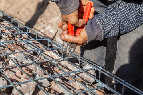 installation of metal gabion mesh manually close-up. construction of gabions in a park in the city