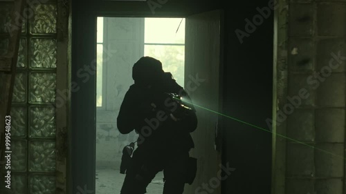 Wallpaper Mural SWAT operator in all black gear and an assault rifle breaching a door in an abandoned warehouse Torontodigital.ca