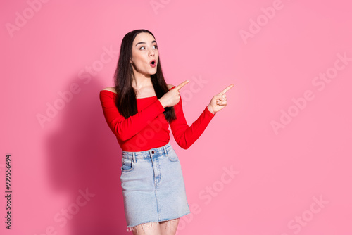 Photo of nice young girl direct fingers empty space red top isolated on pink color background