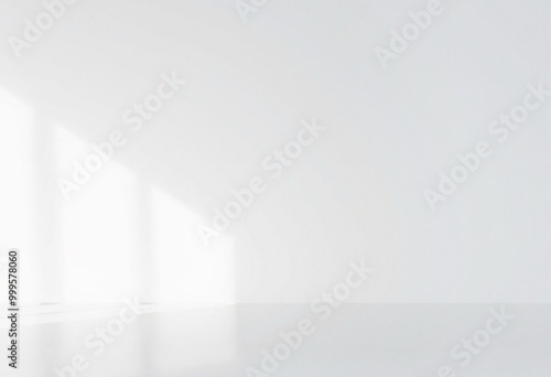 Minimalist white room with soft light shining through the window.