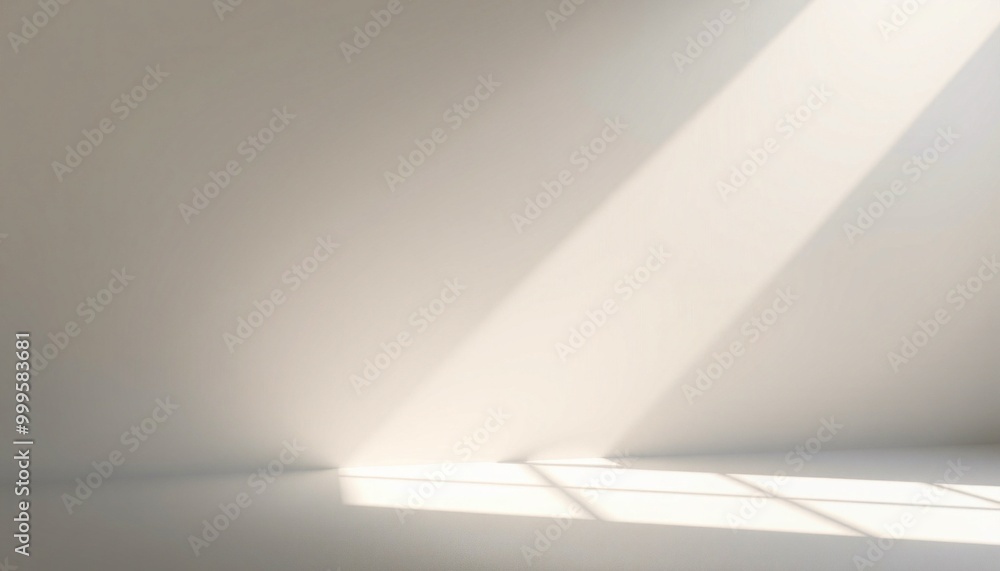 Minimalist white room with sunlight streaming in through a window, casting long shadows on the floor. Minimalist white room with sunlight streaming in through a window, casting long shadows on the floor.