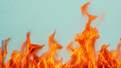 Flames dancing against a soft blue background, creating a striking visual contrast.