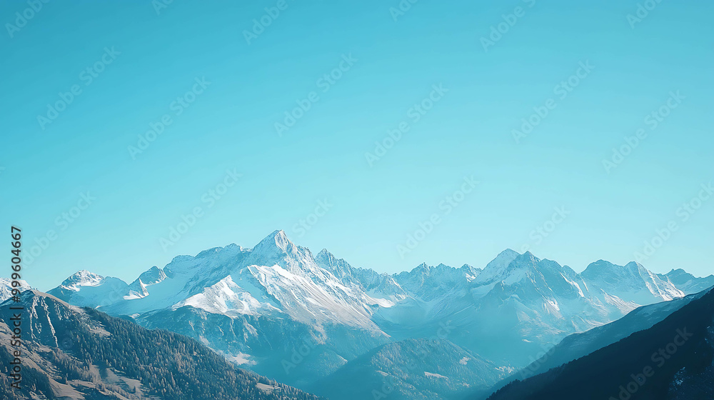 A panoramic view of snow-capped mountains against a clear blue sky. A panoramic view of snow-capped mountains against a clear blue sky.