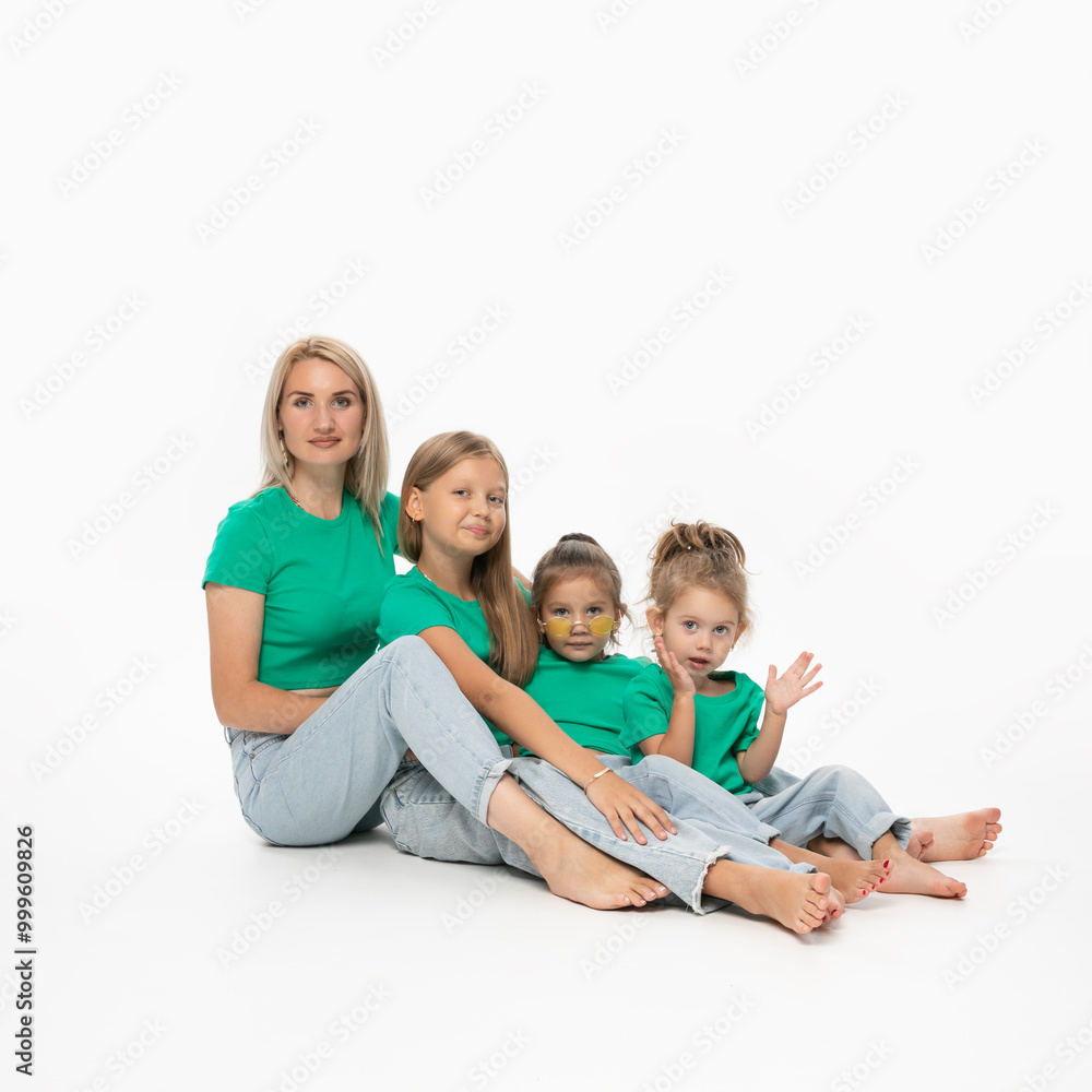 Happy modern family concept. Young mom with her daughters, posing in studio, isolated white background. Happy modern family concept. Young mom with her daughters, posing in studio, isolated white background.