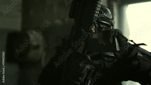 Wallpaper Mural Quick reaction force operator in black stealthy outfit inserting a magazine in his m4 assault rifle Torontodigital.ca