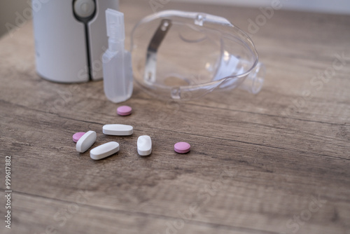 The pills in close-up against the background of a nebulizer. Treatment of colds during the disease season