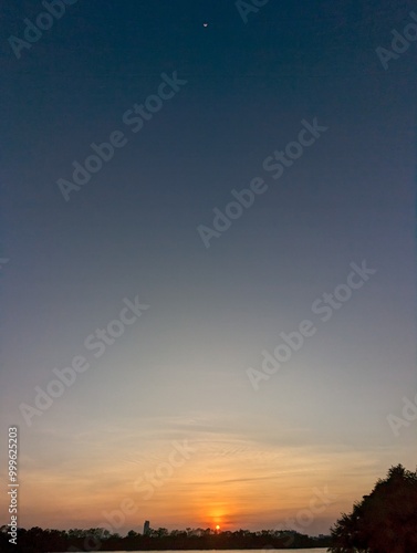 Evening Moon and sun together above Bangkok sky