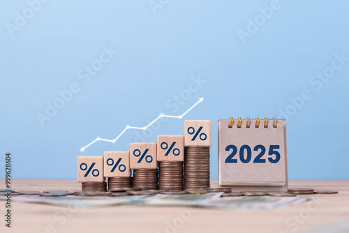 2025 new year calendar with increasing arrow and stack of money as financial saving rising concept. increasing of interest rates, business profit growth. Financial investment. Inflation. tax. dividend photo