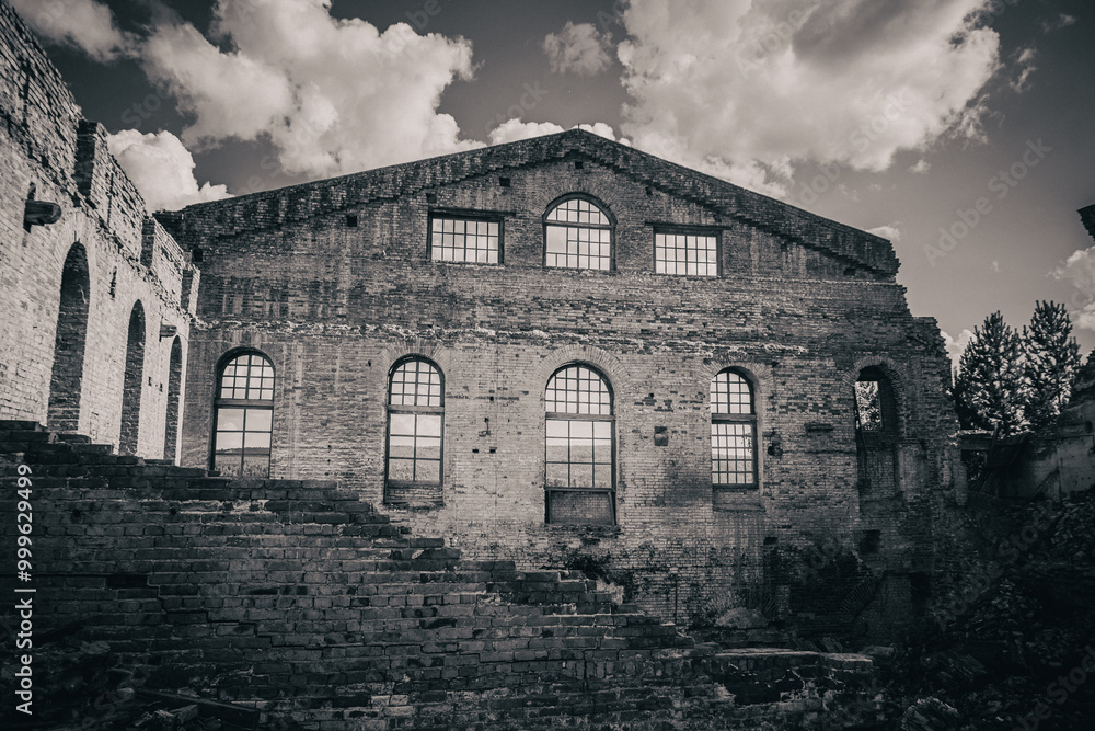 Fototapeta premium Ruins of an old abandoned factory building. Black and white photo.