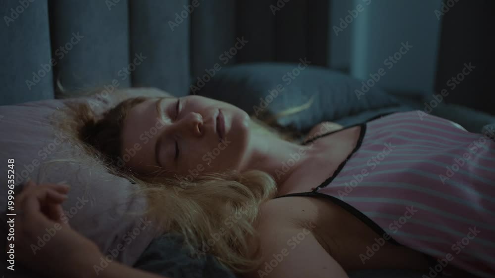 Young woman peacefully sleeping in a dimly lit bedroom with a phone nearby Young woman peacefully sleeping in a dimly lit bedroom with a phone nearby