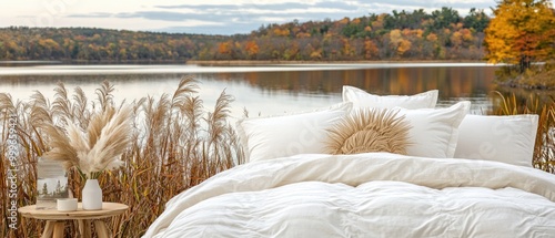 Cozy bed setup by a serene lakeside in autumn