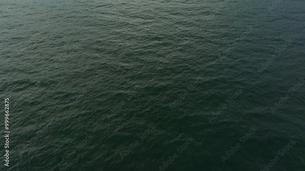 Calm Ocean Waves Rolling Gently in the Early Morning Light at a Serene Coastal Location Calm Ocean Waves Rolling Gently in the Early Morning Light at a Serene Coastal Location
