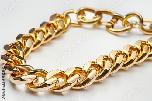 A single gold chain bracelet lying on a white surface