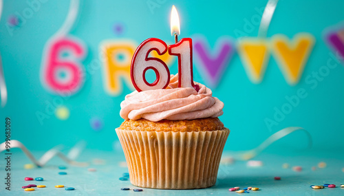 Birthday cupcake with burning lit candle with number 61. Number sixty-one for sixty-one years or sixty-first anniversary. photo