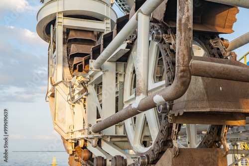 Industrial Machinery Close-Up.  Close-up of industrial machinery with intricate gears, chains and wheels,  photo