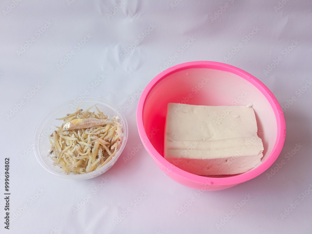two bowls of tofu and anchovies isolated on white two bowls of tofu and anchovies isolated on white