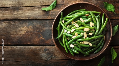 Wallpaper Mural A bowl of green beans topped with sliced almonds on a wooden table. Torontodigital.ca