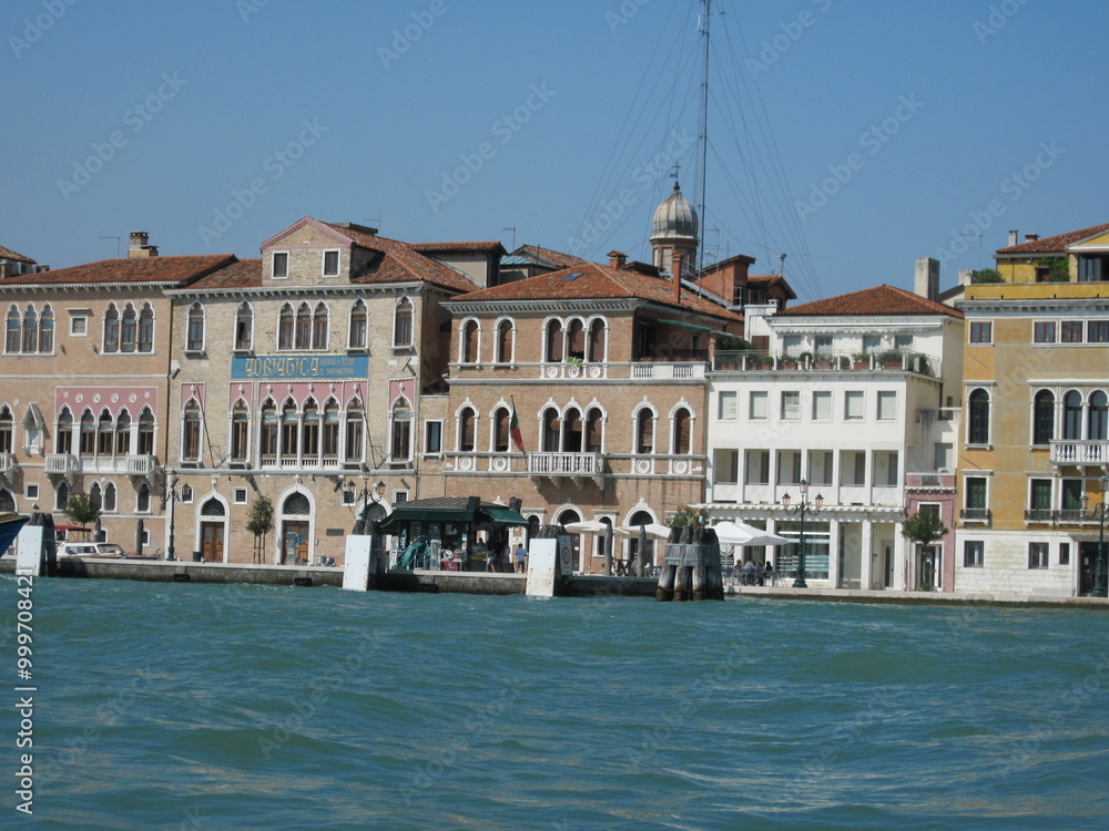 Obraz premium Romantic Venetian landscape. Tourists in a gondola on a walk along a Grand Canal in the old town. Famous historical heritage city.