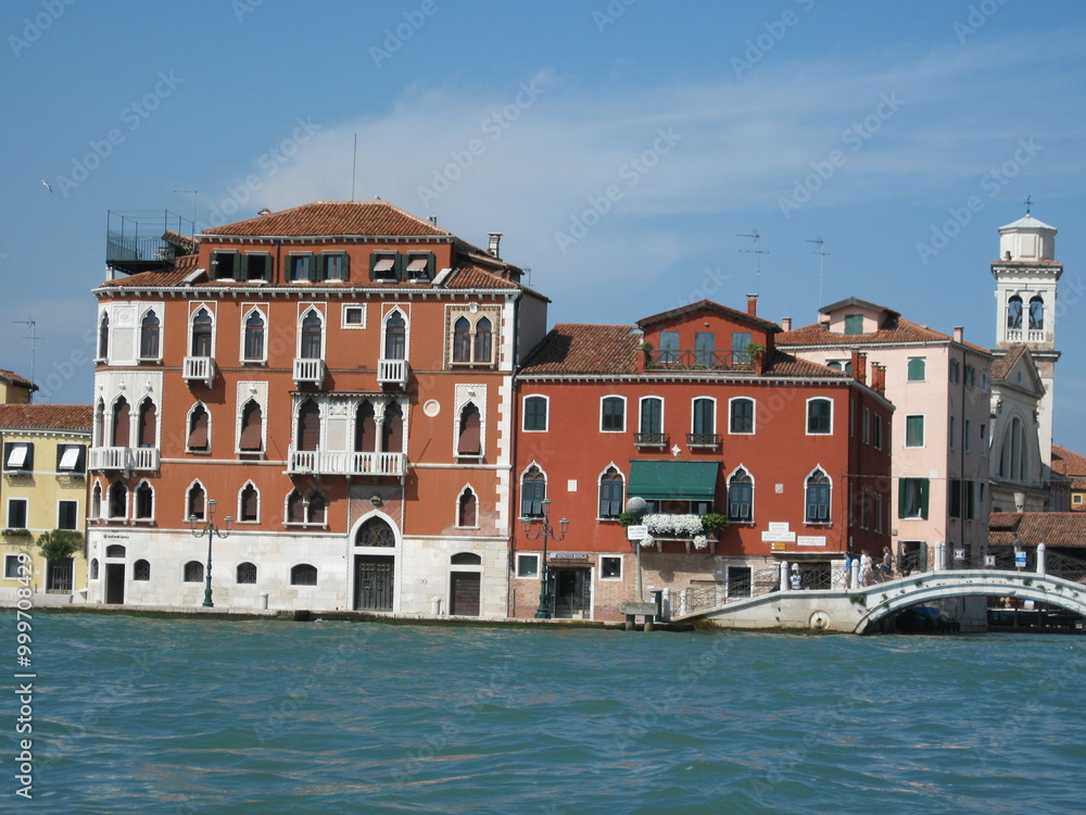 Obraz premium Romantic Venetian landscape. Tourists in a gondola on a walk along a Grand Canal in the old town. Famous historical heritage city.