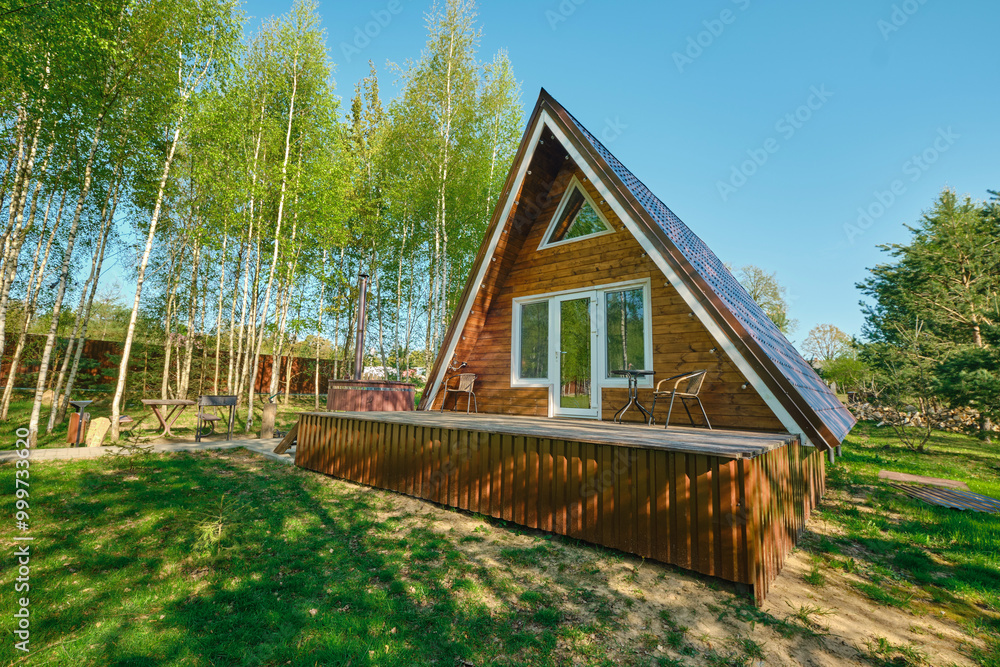 Cozy wooden cabin with modern design nestled among lush greenery in a serene outdoor setting
