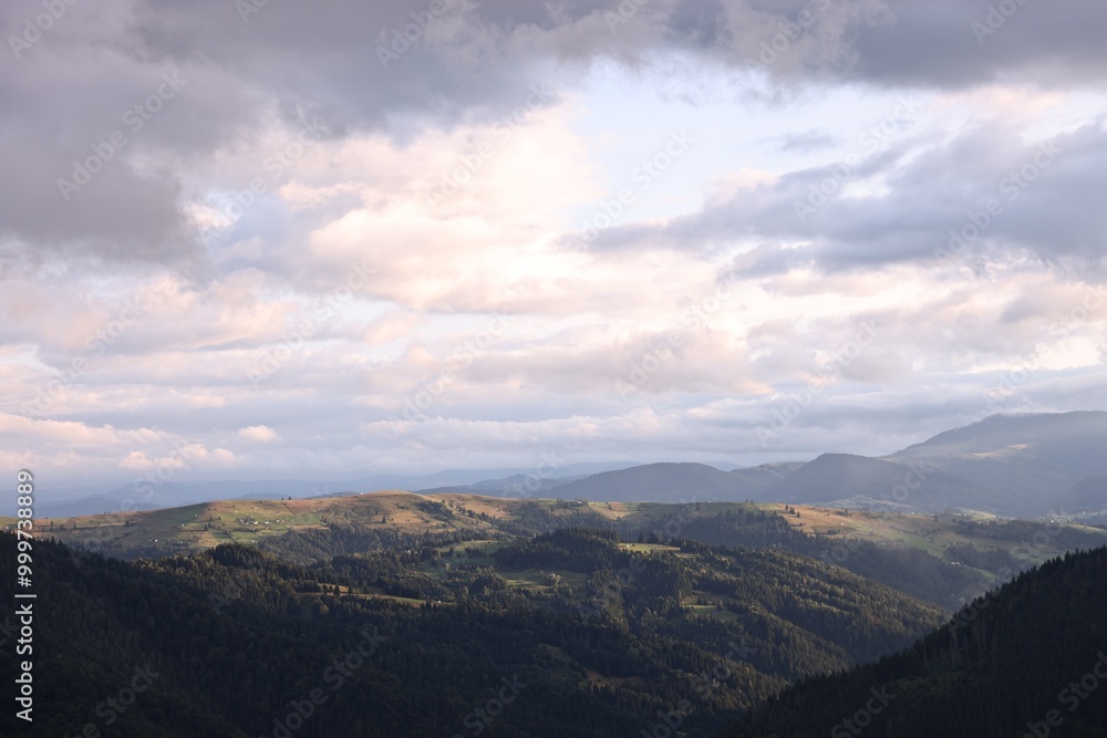 Picturesque view of beautiful mountains under cloudy sky Picturesque view of beautiful mountains under cloudy sky
