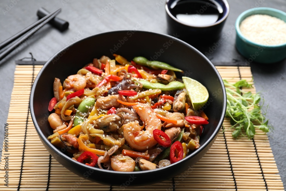 Stir-fry sea food served on grey table, closeup Stir-fry sea food served on grey table, closeup