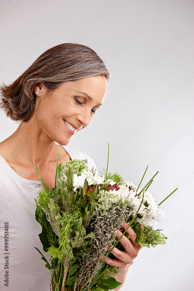 Bouquet, studio and mature woman with smile, thinking and happy with gift, mothers day and celebration. White background, birthday and bunch of flowers for person, joy and contemplating with present Bouquet, studio and mature woman with smile, thinking and happy with gift, mothers day and celebration. White background, birthday and bunch of flowers for person, joy and contemplating with present