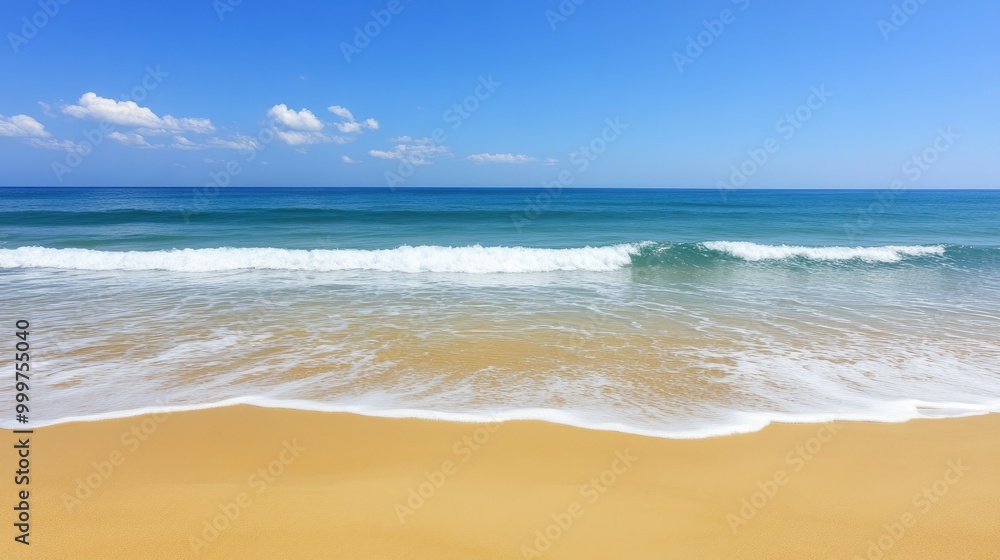 Naklejka premium A serene beach scene with golden sand and gentle waves under a clear blue sky.