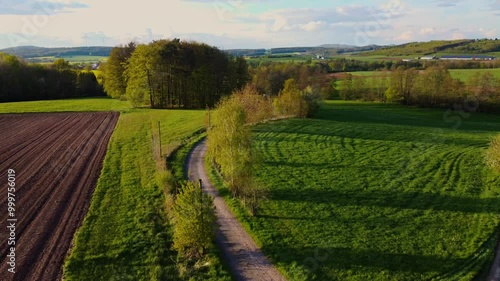 A breathtaking aerial view of rural USA in springtime, showcasing lush meadows, forests, and agricultural fields under a vibrant sky. Idyllic, peaceful, and full of natural beauty.