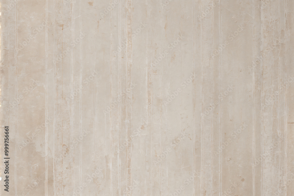 A pale pink wallpaper with a floral design in gold