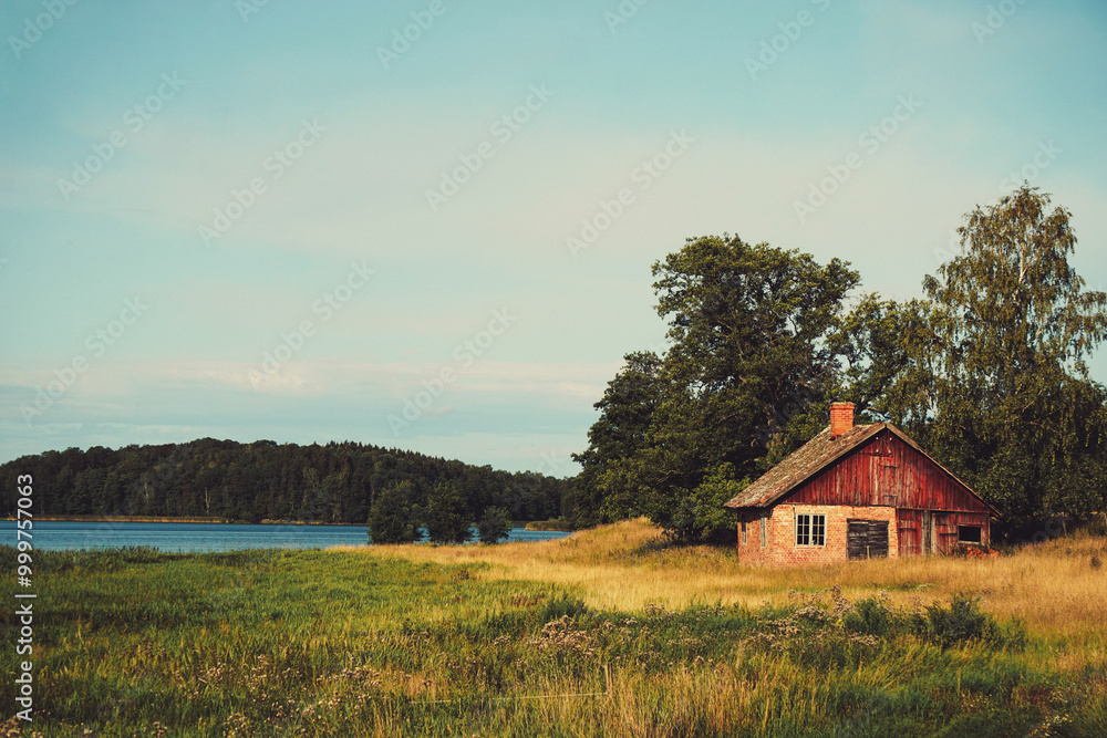 An abandoned house by a lake An abandoned house by a lake