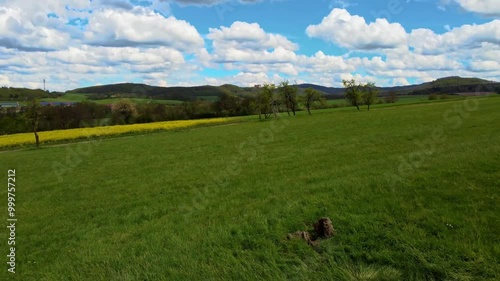 A breathtaking aerial view of rural USA in springtime, showcasing lush meadows, forests, and agricultural fields under a vibrant sky. Idyllic, peaceful, and full of natural beauty.