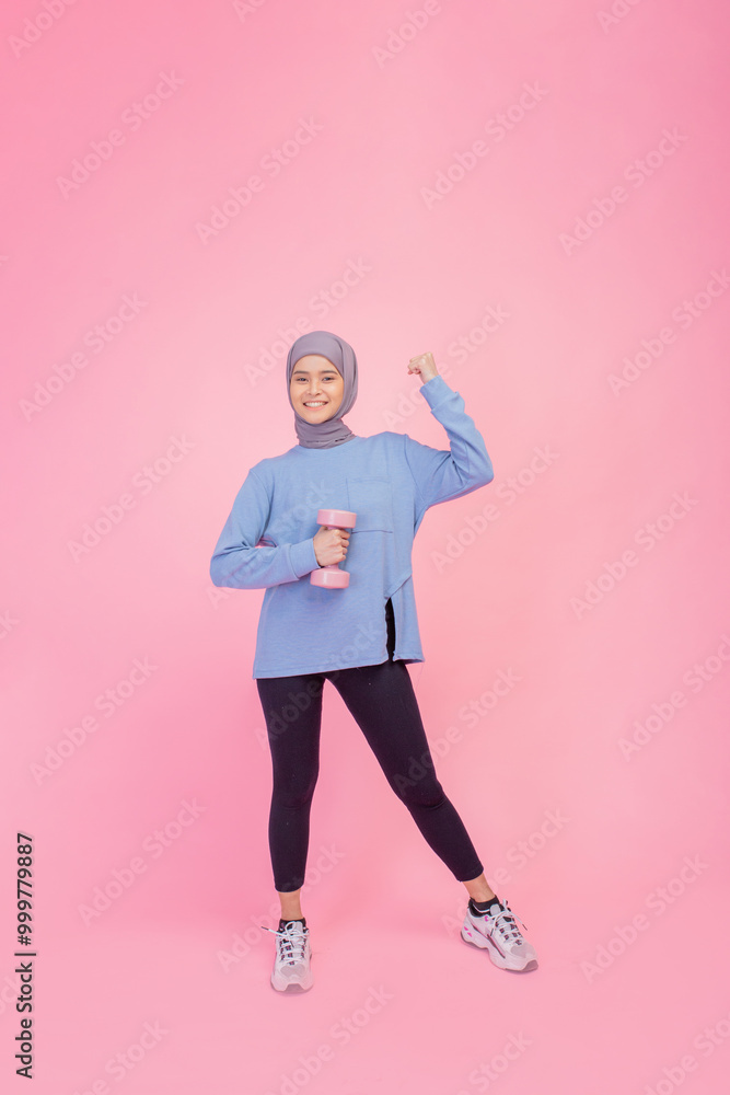 A confident woman in vibrant activewear showcasing her strength while lifting a dumbbell A confident woman in vibrant activewear showcasing her strength while lifting a dumbbell