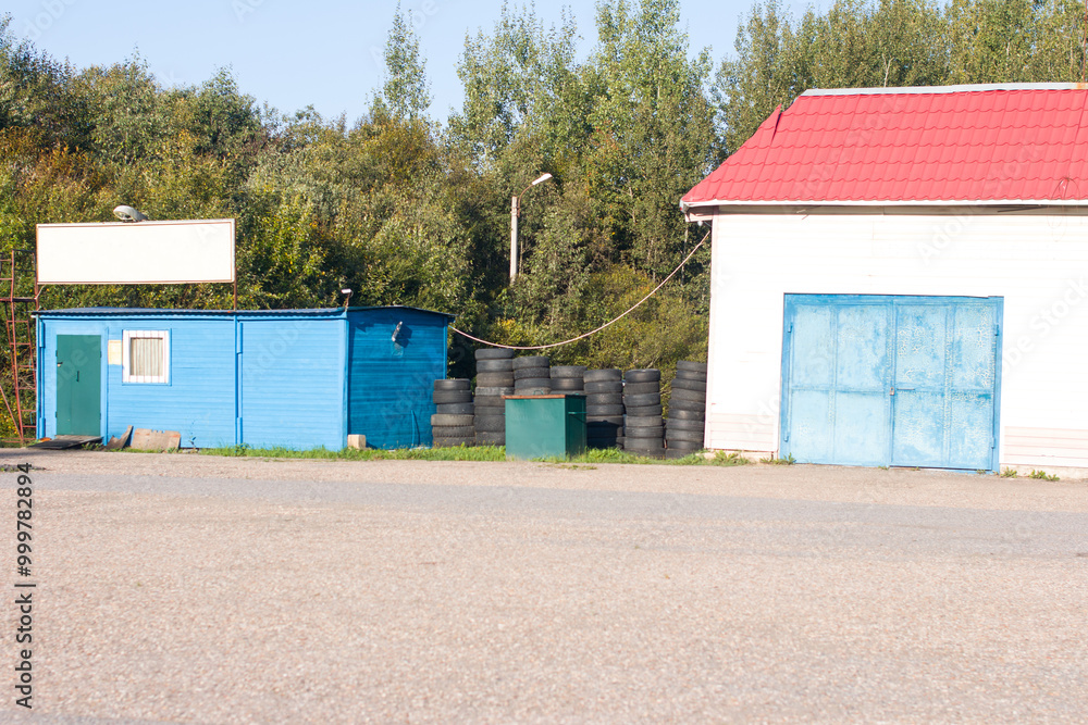 A service center for replacing wheels for a car, Tire service. The rubber wheels are in a row A service center for replacing wheels for a car, Tire service. The rubber wheels are in a row