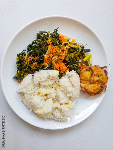 Urap Sayur. healthy and traditional indonesian food isolated on white photo