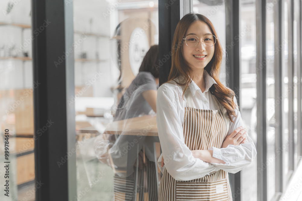 Happy proud young female coffee shop owner standing outside of her shop crossing her arms smiling at camera Happy proud young female coffee shop owner standing outside of her shop crossing her arms smiling at camera