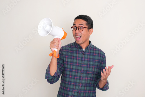 A man holding megaphone with excited expression photo