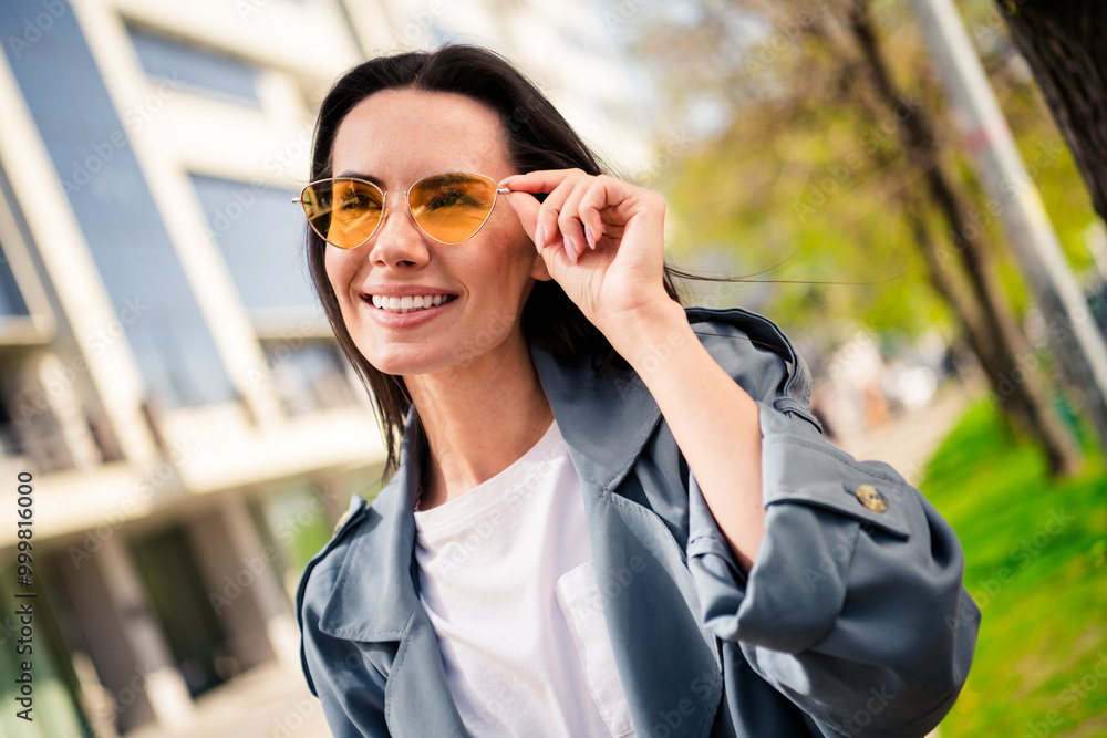 Photo of cheerful pretty lady dressed grey jacket dark eyewear enjoying sunshine outdoors town street Photo of cheerful pretty lady dressed grey jacket dark eyewear enjoying sunshine outdoors town street