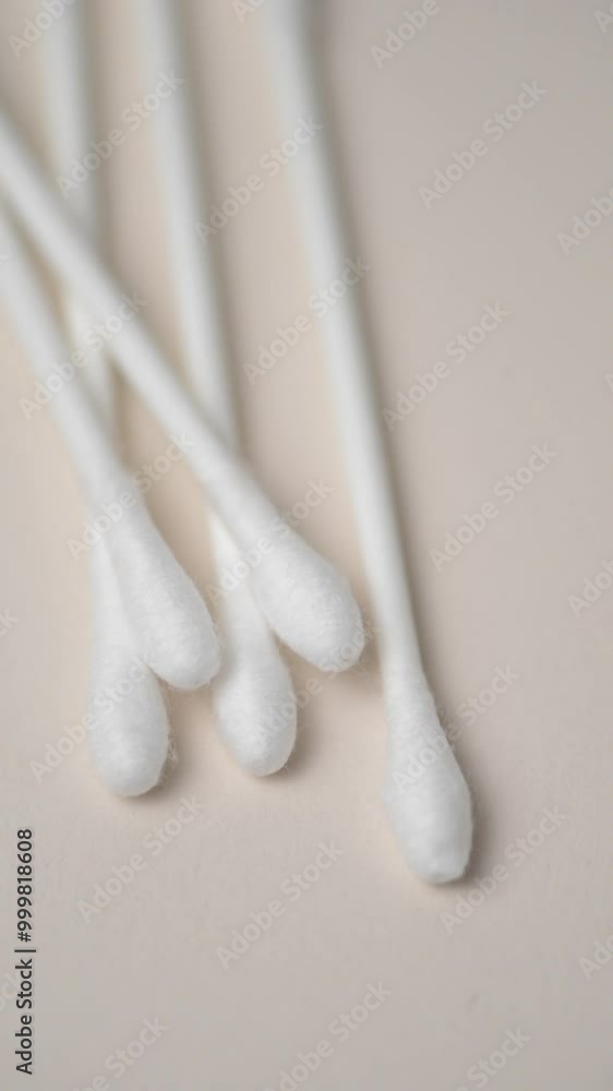 Cotton swabs close up orderly aligned on white background rotating in motion, vertical video
Cotton swabs close up orderly aligned on white background rotating in motion, vertical video