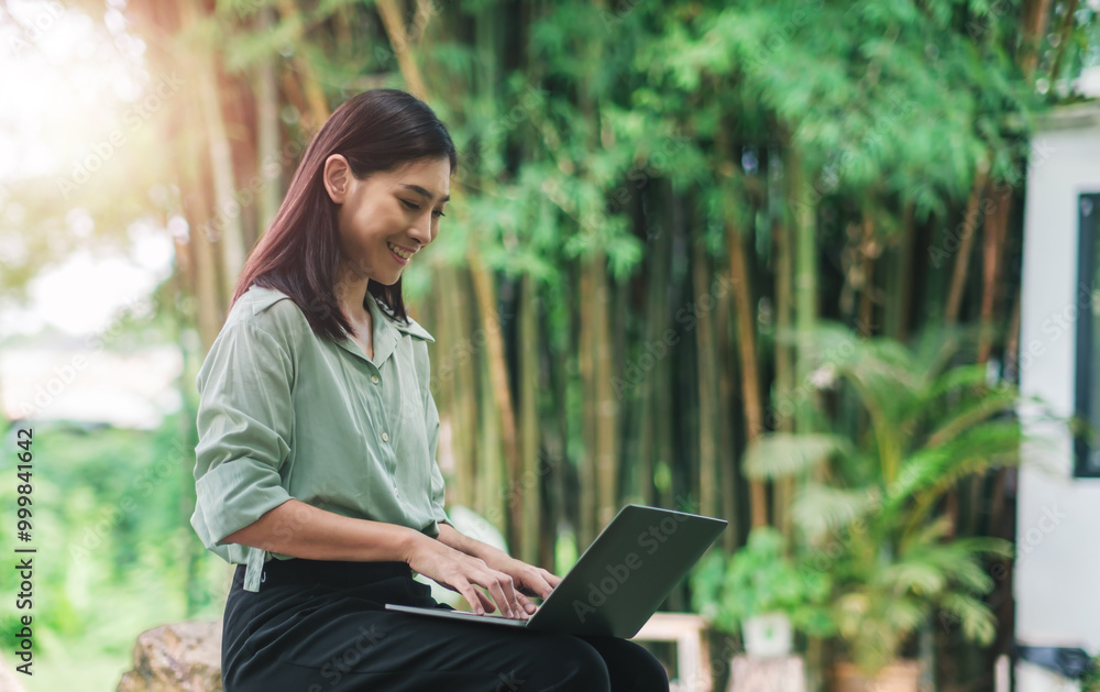 © Have a nice day - Asian business woman working outside typing on computer laptop device wireless remote communication technology, connectivity digital online freelance worker casual outdoor in nature at cafe sunlight. © Have a nice day - Asian business woman working outside typing on computer laptop device wireless remote communication technology, connectivity digital online freelance worker casual outdoor in nature at cafe sunlight.
