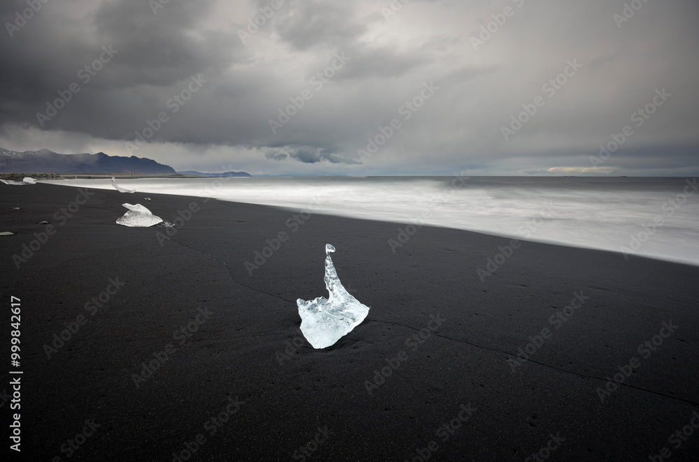 melted ice chunks on the black sand beach at Fellsfjara (Diamond beach), Jökulsárlón Glacier Lagoon, Iceland melted ice chunks on the black sand beach at Fellsfjara (Diamond beach), Jökulsárlón Glacier Lagoon, Iceland