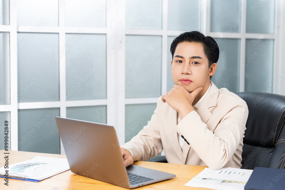 Asian businessman working in his office reviewing work, accessing planning strategy, creative thinking and innovation ideas, sitting at his desk using laptop computer, professional business worker. Asian businessman working in his office reviewing work, accessing planning strategy, creative thinking and innovation ideas, sitting at his desk using laptop computer, professional business worker.