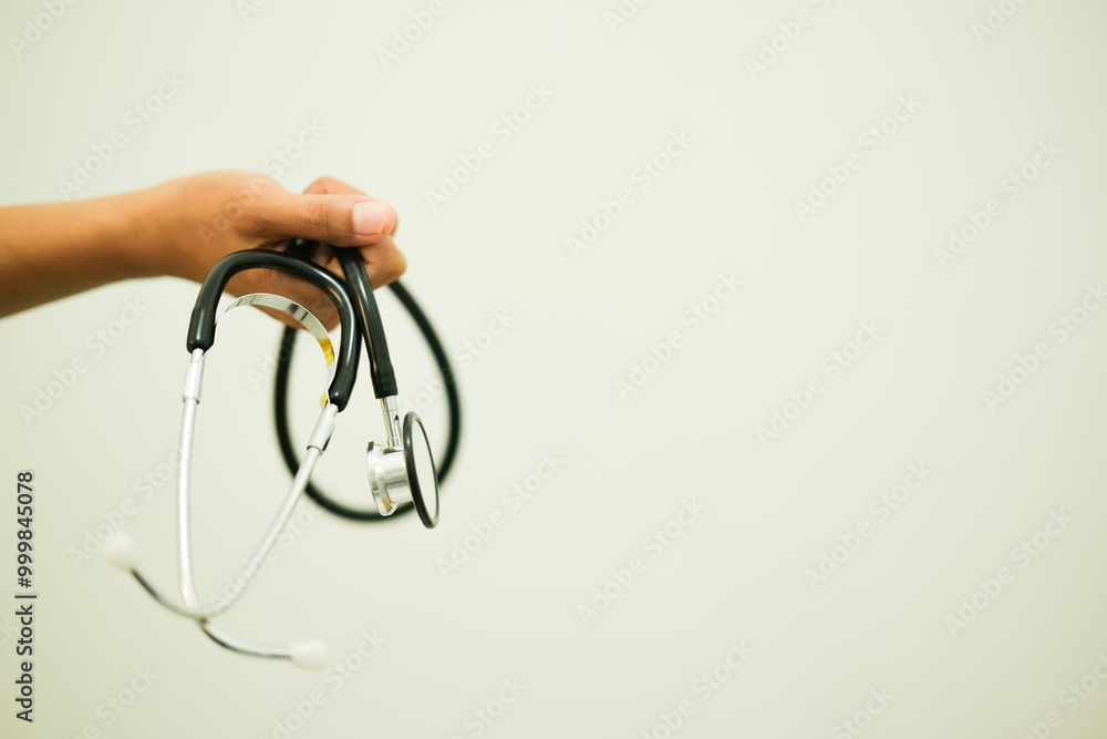 Doctor's Hand Holding Stethoscope, Isolated on White background Doctor's Hand Holding Stethoscope, Isolated on White background