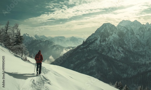 Hiker on snowy mountain with breathtaking views of alpine peaks