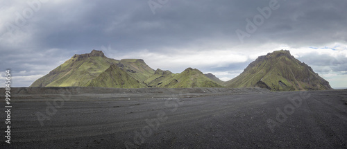 Green mountain range and Mýrdalssandur black lava sand flats near Katla volcano, VÍk, South Iceland
